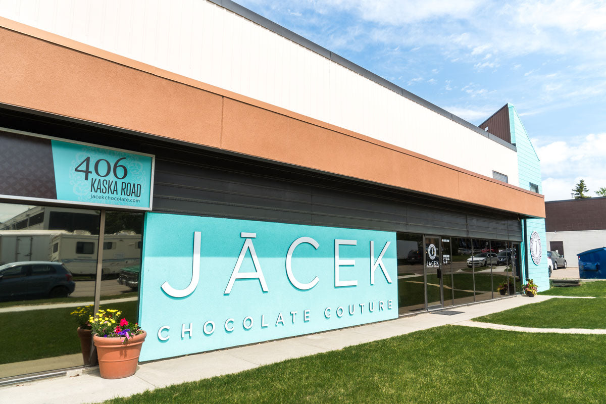 The exterior of the JACEK Studio. A large teal wall is featured, which reads 